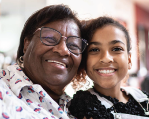 close up of Black grandmother with middle school aged granddaughter