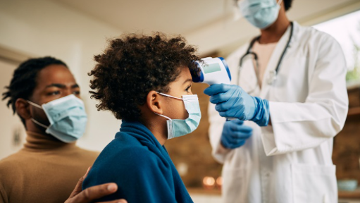 Man with child while nurse takes child's temperature