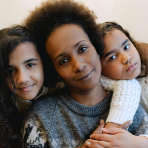 mother and two daughters embracing