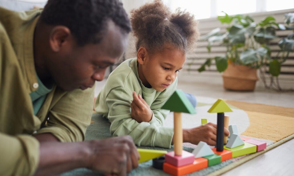 Black father and his young child playing with colorful blocks