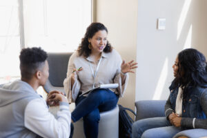 Woman talking in a small group meeting with two others