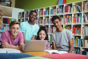 Portrait of happy students in library