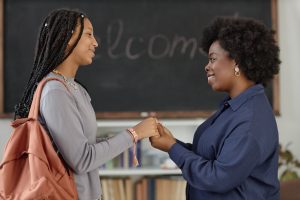 Teenage Girl Thanking Teacher in Classroom