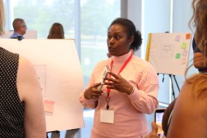 Parent leader Alexis presents her plan at the 2026 Academy final event to other leaders