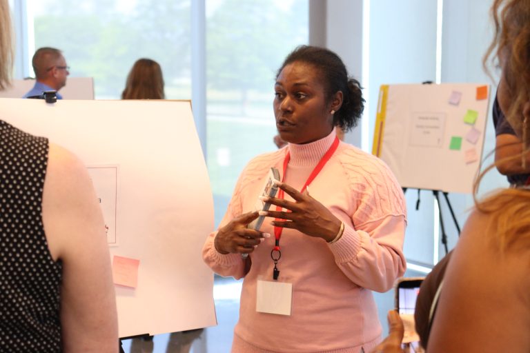 Parent leader Alexis presents her plan at the 2026 Academy final event to other leaders