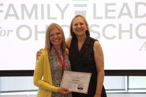 Parent leader Beth receiving a certificate of completion for the Family Leaders for Ohio Schools Academy, from Dr. Boone from Ohio State